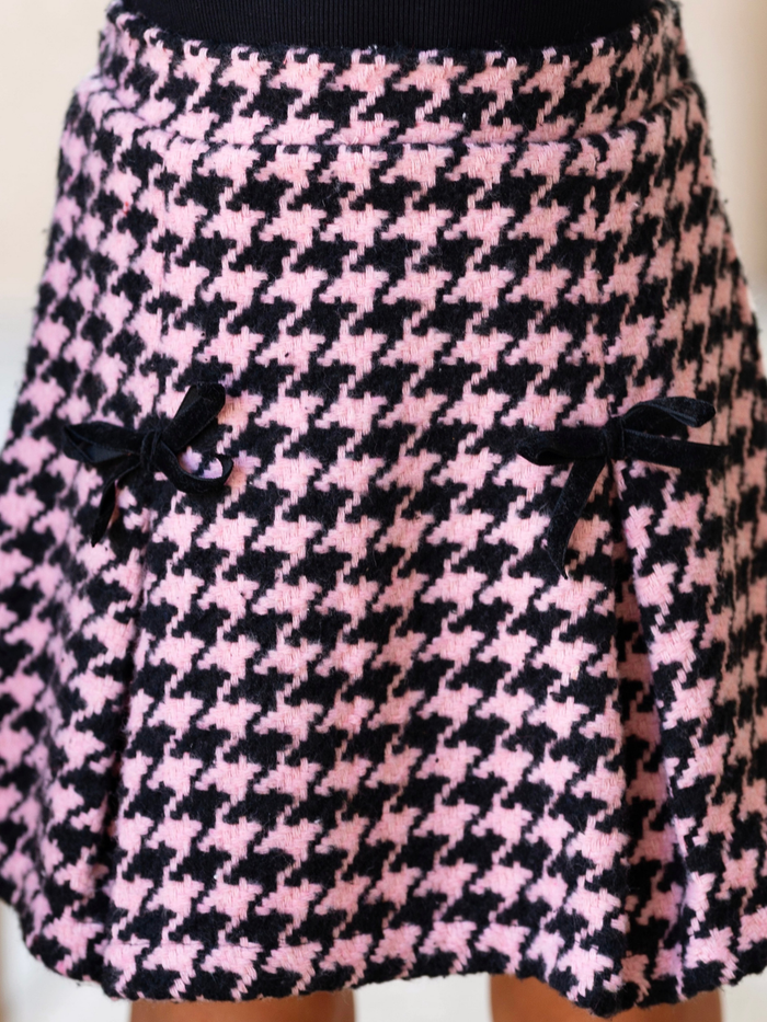 Girl wearing a pink houndstooth skirt for fall special occasions