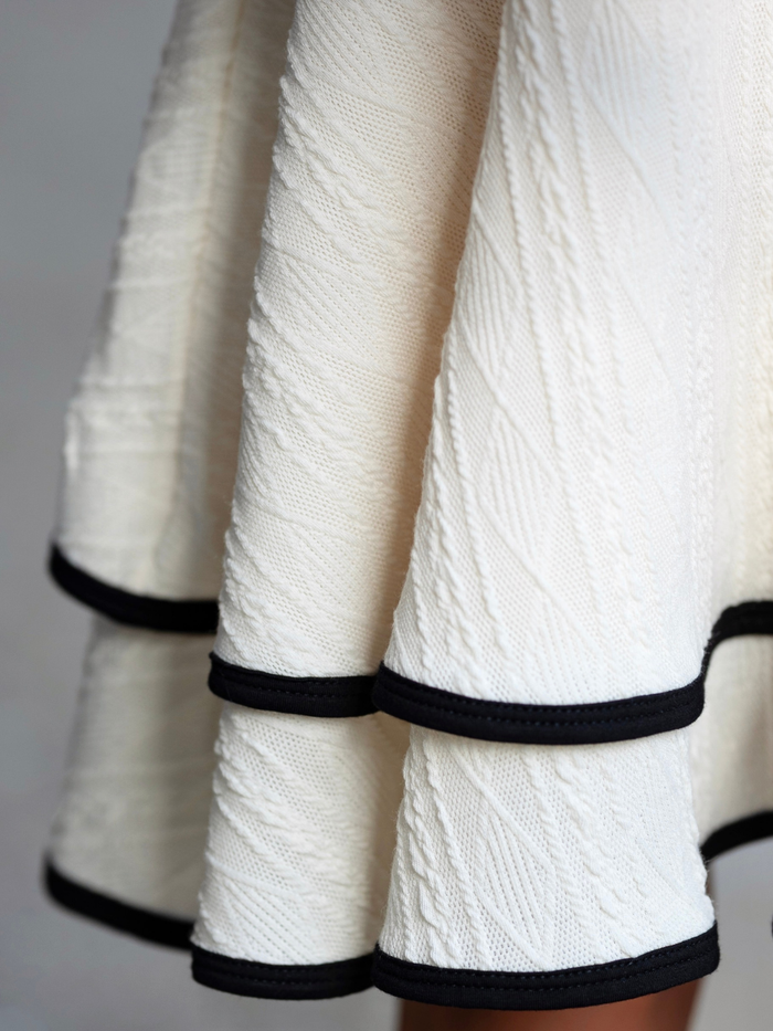 Girls ivory dress with black contrast trim