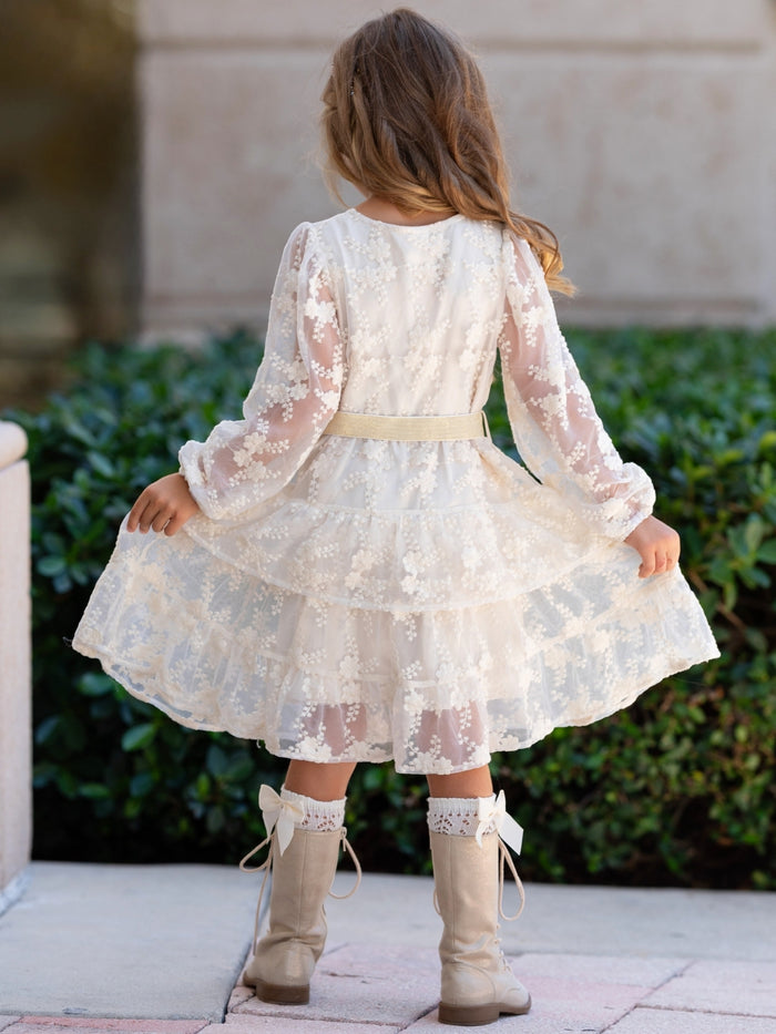 Girls long sleeve ivory dress with decorative button front.