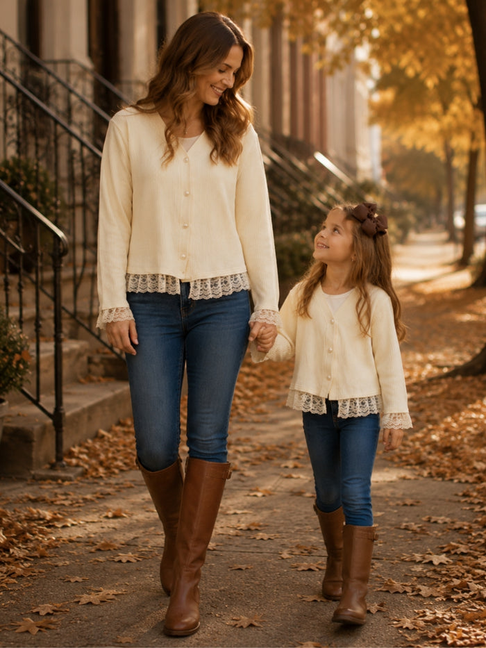 Mommy and daughter wearing matching ivory lace trim cardigans.