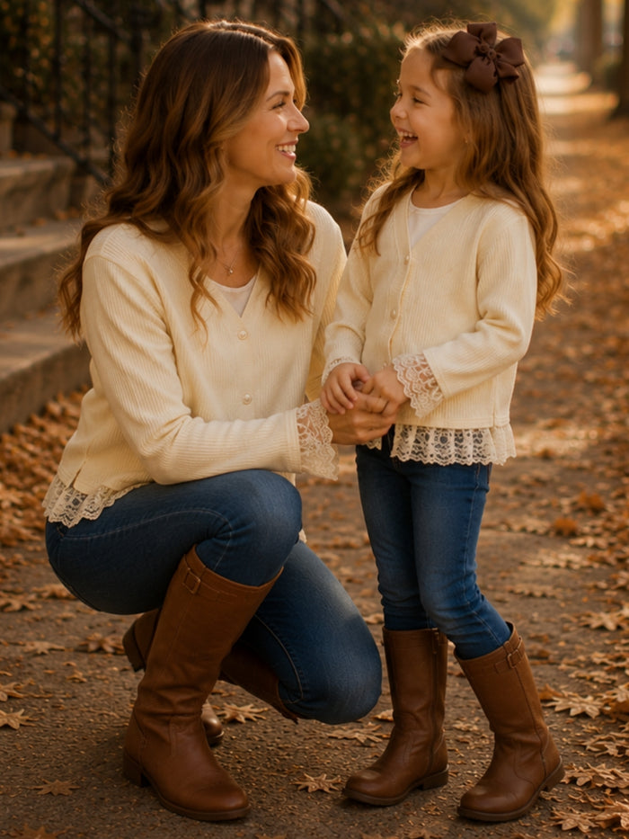 Mom and daughter coordinating ivory button-front cardigans.