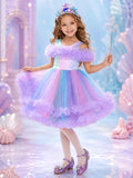 Girl wearing a Pastel Sea Princess Unicorn Halloween costume with a rainbow pastel dress.