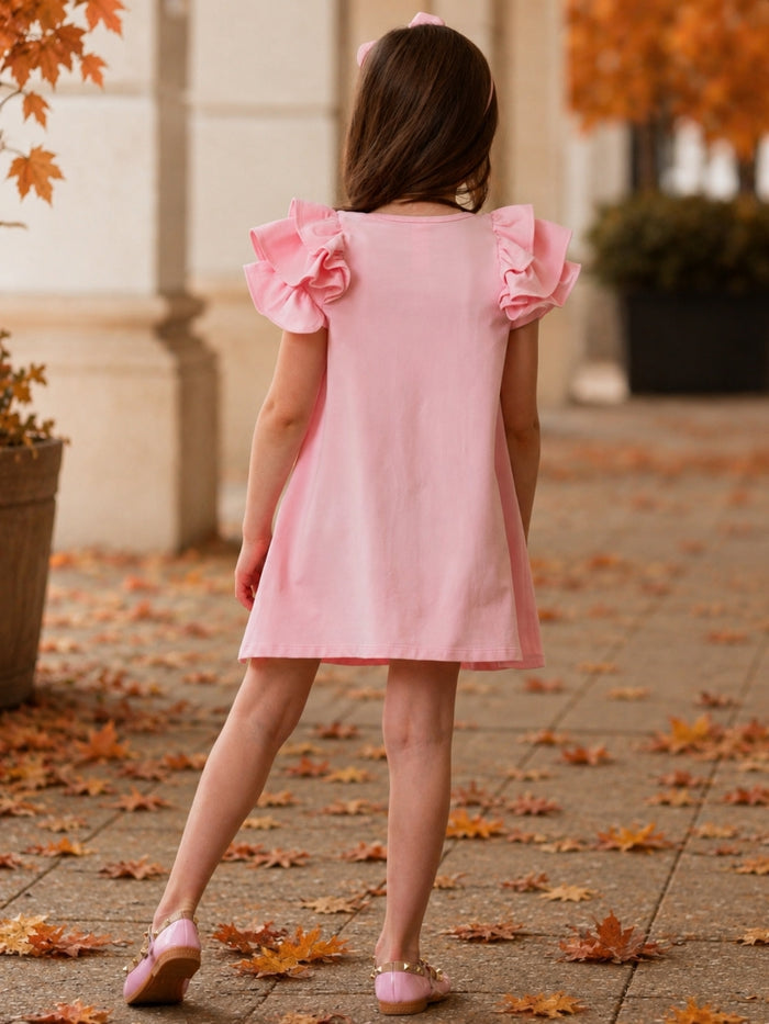 Girls pink dress with layered ruffle sleeves.