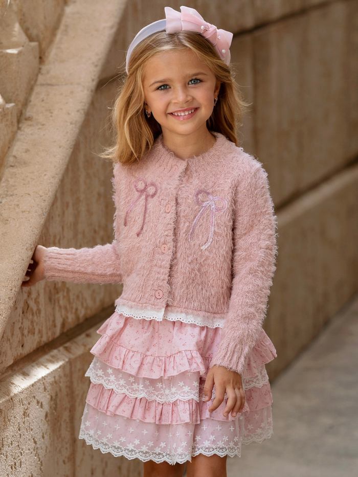 Girl wearing a blush pink cardigan and layered lace skirt set for fall and holiday special occasions.