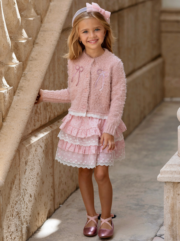 Girl wearing a blush pink cardigan and layered lace skirt set for fall and holiday special occasions.