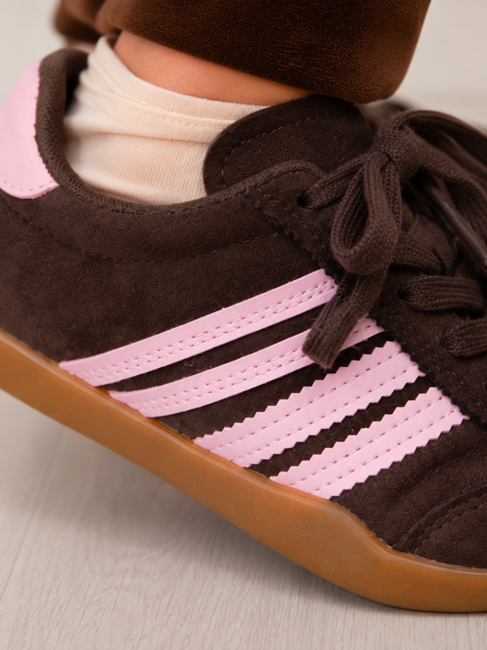 Girls lace up sneakers featuring pink side stripes
